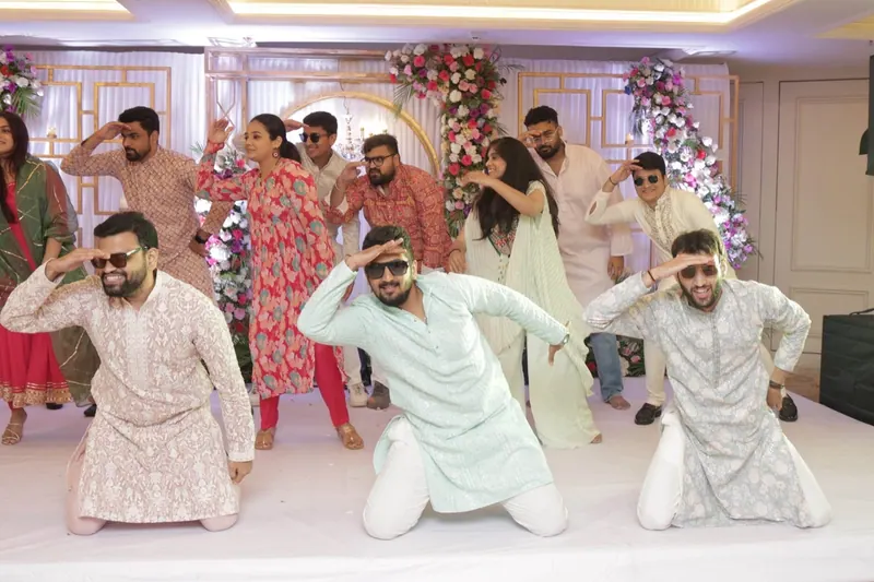 Groom's friends performing a choreographed dance at the sangeet